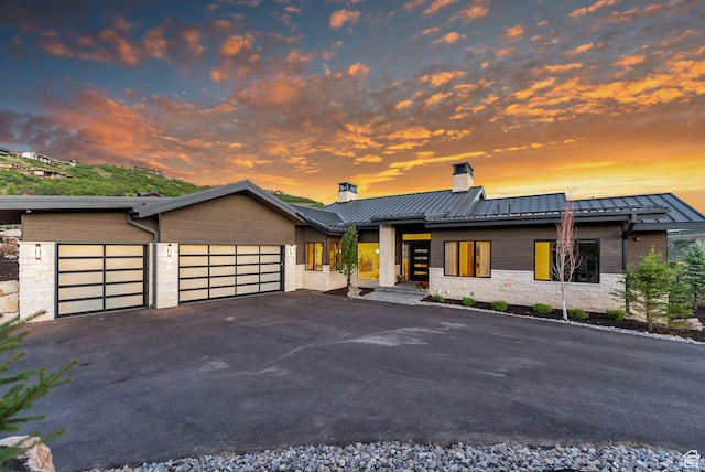 2344 Nighthawk Cir, Park City, UT 84098 - contemporary house featuring an attached garage, a standing seam roof, metal roof, and aphalt driveway