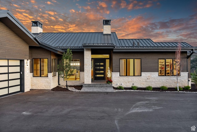 2344 Nighthawk Cir, Park City, UT 84098 - view of front of home with a garage, a standing seam roof, a chimney, and metal roof