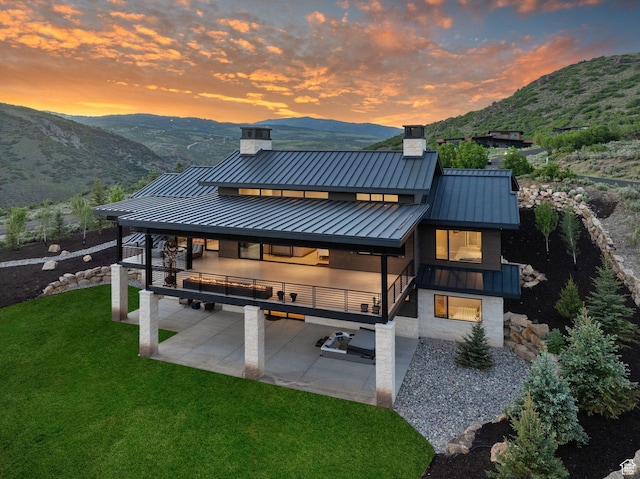 2344 Nighthawk Cir, Park City, UT 84098 - back of house with a yard, a patio, a standing seam roof, a mountain view, and metal roof