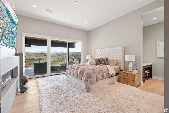 2344 Nighthawk Cir, Park City, UT 84098 - bedroom featuring recessed lighting, access to outside, light wood-style flooring, and a glass covered fireplace