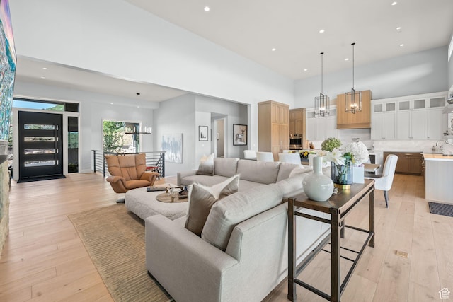 2344 Nighthawk Cir, Park City, UT 84098 - living area featuring a high ceiling, light wood-type flooring, recessed lighting, and an inviting chandelier