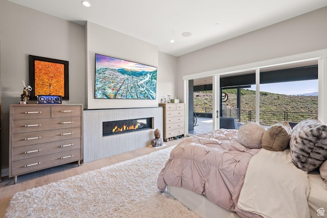 2344 Nighthawk Cir, Park City, UT 84098 - bedroom featuring recessed lighting, access to outside, wood finished floors, and a glass covered fireplace