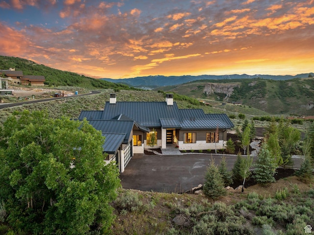 2344 Nighthawk Cir, Park City, UT 84098 - rear view of property featuring metal roof, a patio, a mountain view, a standing seam roof, and a chimney