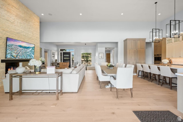 2344 Nighthawk Cir, Park City, UT 84098 - living room with a chandelier, light wood-type flooring, a towering ceiling, and recessed lighting