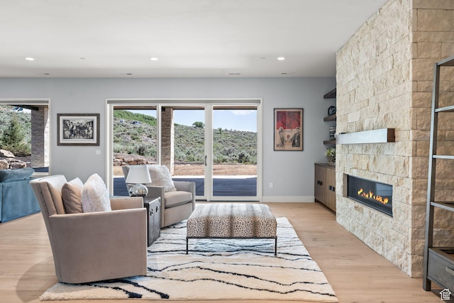 2344 Nighthawk Cir, Park City, UT 84098 - living room featuring recessed lighting, light wood-style flooring, baseboards, and a stone fireplace