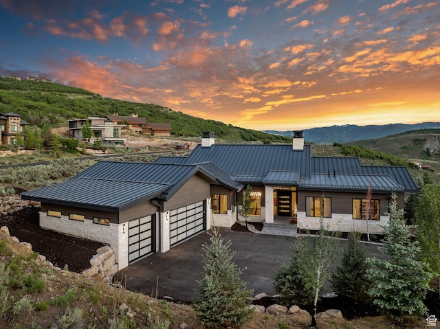 2344 Nighthawk Cir, Park City, UT 84098 - modern home featuring a chimney, an attached garage, a standing seam roof, a mountain view, and metal roof