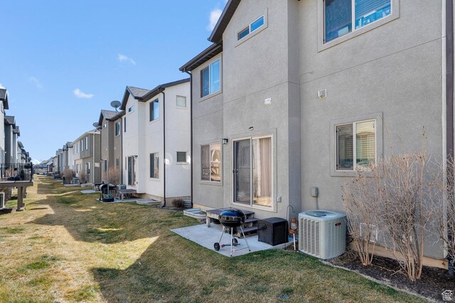 2616 N Elm Dr, Lehi, UT 84043 - back of house featuring a patio, a residential view, a yard, central air condition unit, and stucco siding