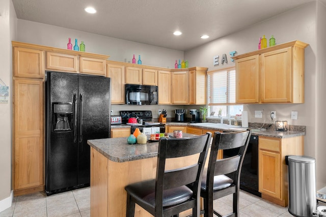 2616 N Elm Dr, Lehi, UT 84043 - kitchen with a center island, a breakfast bar area, light brown cabinetry, a sink, and black appliances