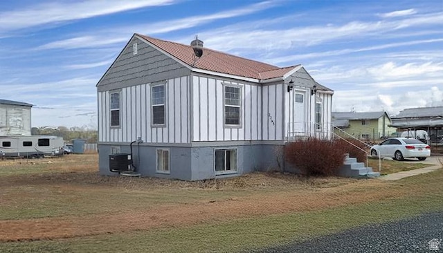 view of side of home featuring board and batten siding and cooling unit