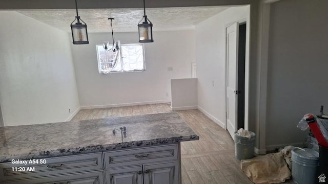 2245 W 500 S, Vernal, UT 84078 - kitchen with baseboards, gray cabinets, light wood-style flooring, and decorative light fixtures