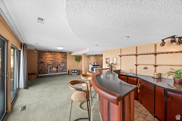 3604 S Crestwood Dr, Salt Lake City, UT 84109 - bar featuring a textured ceiling, a stone fireplace, visible vents, and light colored carpet