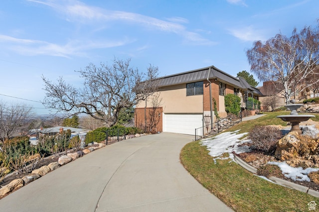 3604 S Crestwood Dr, Salt Lake City, UT 84109 - view of home's exterior featuring a garage, brick siding, concrete driveway, and stucco siding