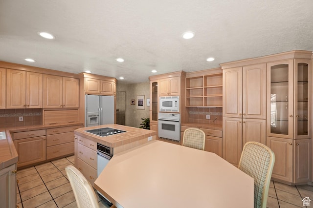 3604 S Crestwood Dr, Salt Lake City, UT 84109 - kitchen with tile countertops, white appliances, light tile patterned flooring, and light brown cabinetry