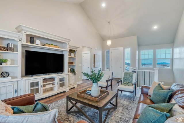 1407 E Abigail Ln, Eagle Mountain, UT 84005 - living area featuring baseboards, high vaulted ceiling, wood finished floors, and recessed lighting