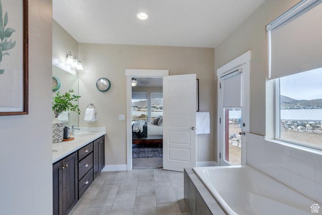1407 E Abigail Ln, Eagle Mountain, UT 84005 - ensuite bathroom with double vanity, tile patterned floors, a sink, ensuite bath, and a bath