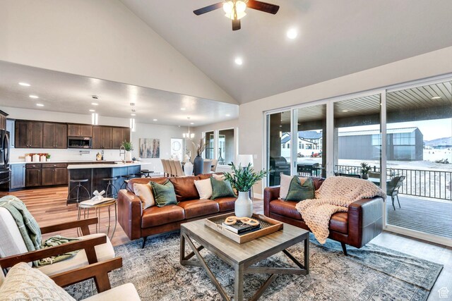 1407 E Abigail Ln, Eagle Mountain, UT 84005 - living area with high vaulted ceiling, recessed lighting, light wood-style flooring, and ceiling fan with notable chandelier
