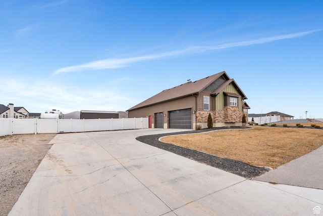 1407 E Abigail Ln, Eagle Mountain, UT 84005 - view of front facade featuring an attached garage, a gate, fence, and concrete driveway
