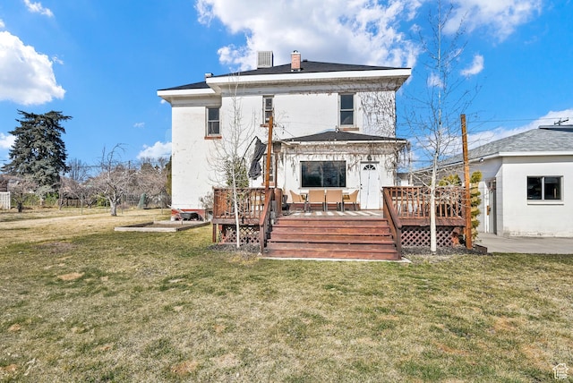back of property with central AC unit, a wooden deck, a chimney, and a lawn