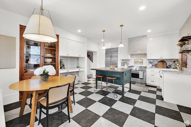 kitchen with premium appliances, recessed lighting, a sink, and decorative backsplash