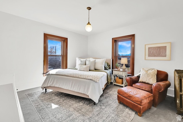 bedroom with dark carpet and baseboards