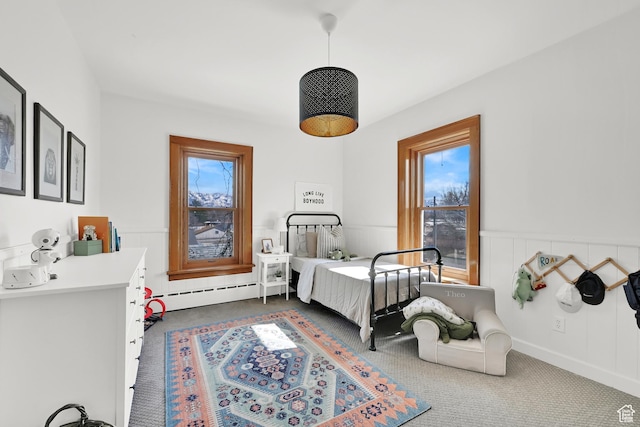 bedroom with carpet and baseboard heating