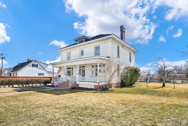 traditional style home with a porch, a chimney, and a front lawn