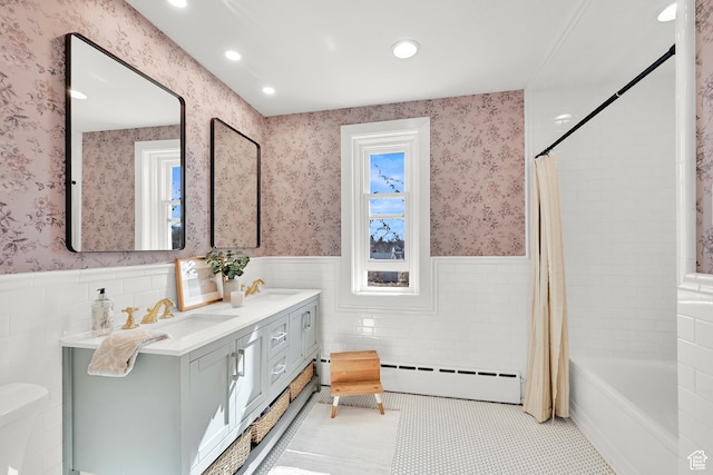 bathroom with a sink, recessed lighting, a baseboard heating unit, and wainscoting