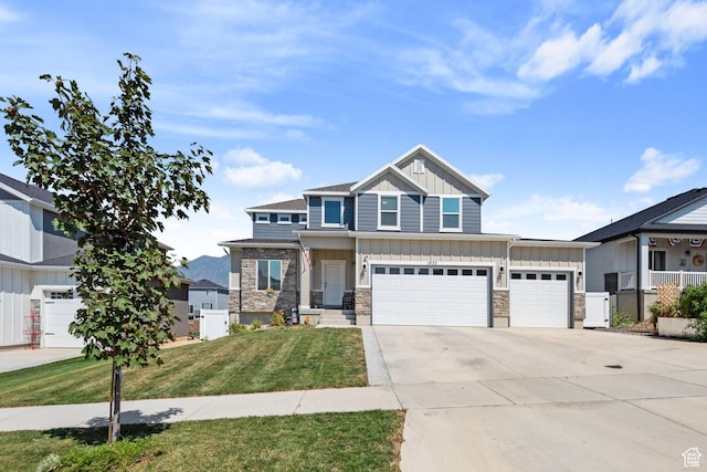 1933 E Handcart Ln N, Spanish Fork, UT 84660 - craftsman-style house with a garage, concrete driveway, stone siding, a front lawn, and board and batten siding