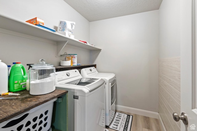 1933 E Handcart Ln N, Spanish Fork, UT 84660 - laundry area featuring a textured ceiling, laundry area, baseboards, light wood-style floors, and washing machine and clothes dryer