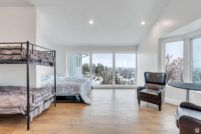 bedroom featuring baseboards, vaulted ceiling, wood finished floors, and recessed lighting