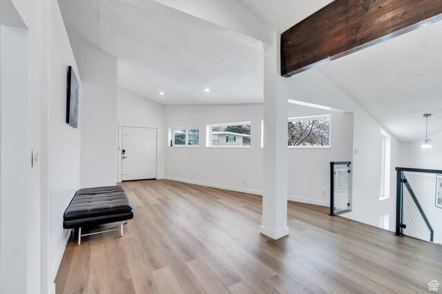 foyer entrance featuring vaulted ceiling with beams, light wood-type flooring, baseboards, and recessed lighting