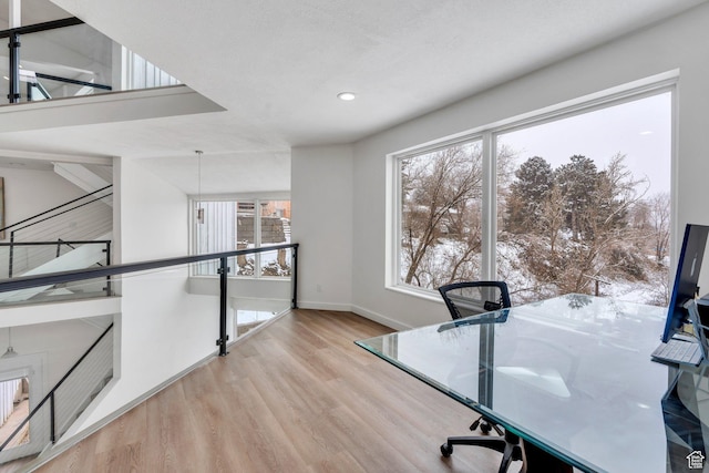 unfurnished office with recessed lighting, baseboards, and wood finished floors