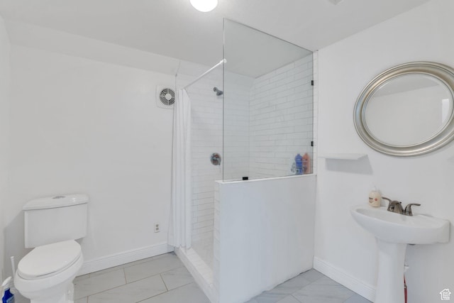full bathroom featuring a walk in shower, marble finish floor, toilet, and baseboards