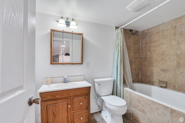full bathroom featuring visible vents, toilet, tiled shower / bath, and vanity