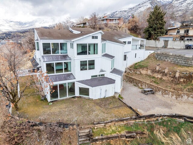 back of property featuring a mountain view