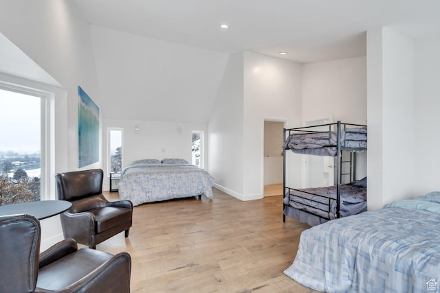 bedroom featuring light wood-type flooring, vaulted ceiling, baseboards, and recessed lighting