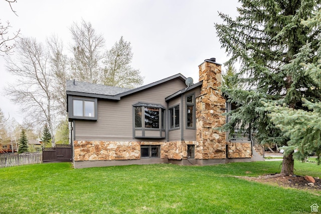 1494 W Meadow Loop Rd, Park City, UT 84098 - view of home's exterior featuring a yard, a chimney, fence, a shingled roof, and stone siding