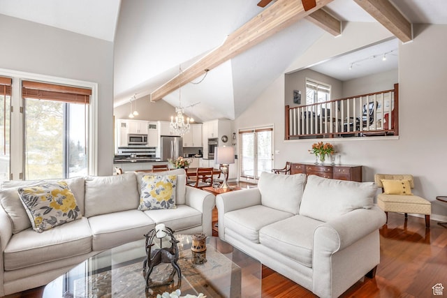 1494 W Meadow Loop Rd, Park City, UT 84098 - living area with rail lighting, beam ceiling, wood finished floors, and a notable chandelier