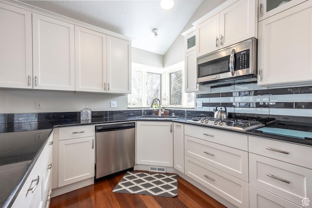 1494 W Meadow Loop Rd, Park City, UT 84098 - kitchen featuring lofted ceiling, visible vents, a sink, white cabinetry, and stainless steel appliances