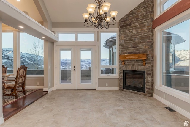 2008 N 3850 E, Eden, UT 84310 - interior space with a chandelier, a stone fireplace, french doors, visible vents, and a mountain view