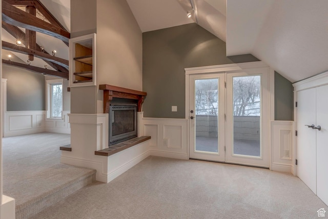 2008 N 3850 E, Eden, UT 84310 - unfurnished living room with wainscoting, a glass covered fireplace, a decorative wall, lofted ceiling, and carpet