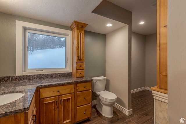2008 N 3850 E, Eden, UT 84310 - bathroom featuring vanity, wood finished floors, toilet, baseboards, and recessed lighting
