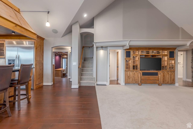2008 N 3850 E, Eden, UT 84310 - living area featuring arched walkways, wood finished floors, stairway, baseboards, and high vaulted ceiling