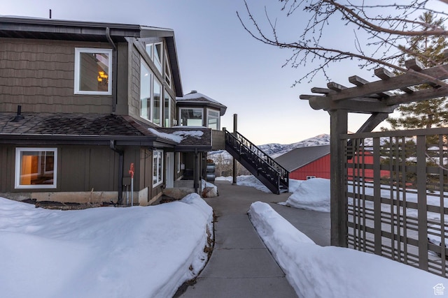 2008 N 3850 E, Eden, UT 84310 - view of snow covered exterior featuring stairway, board and batten siding, and a mountain view