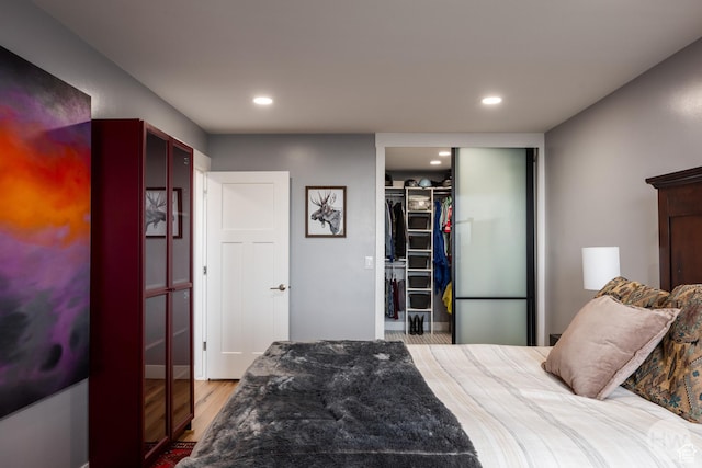 777 E S Temple S Unit 11F, Salt Lake City, UT 84102 - bedroom with wood finished floors, recessed lighting, a walk in closet, and a closet