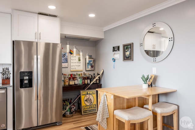 777 E S Temple S Unit 11F, Salt Lake City, UT 84102 - indoor dry bar featuring stainless steel appliances, ornamental molding, light wood-style floors, and recessed lighting