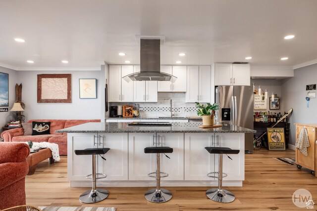 777 E S Temple S Unit 11F, Salt Lake City, UT 84102 - kitchen featuring island range hood, stainless steel fridge, ornamental molding, a sink, and white cabinetry