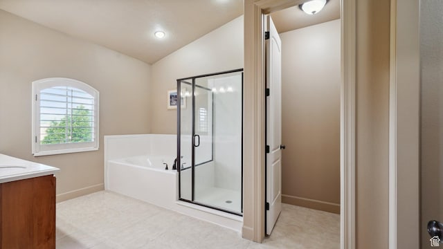 full bath with a shower stall, vanity, baseboards, a garden tub, and lofted ceiling