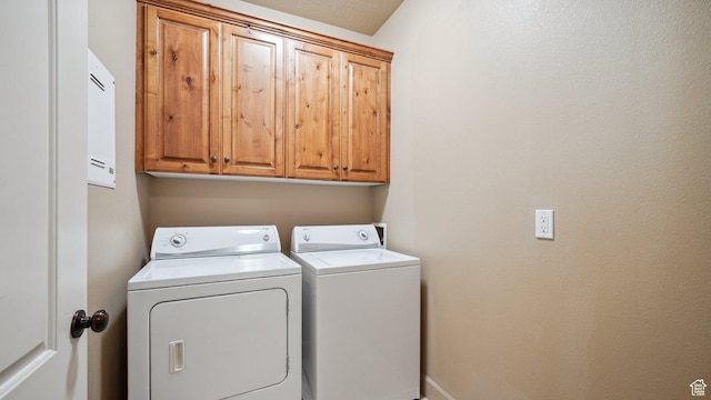 laundry room with cabinet space and washing machine and dryer