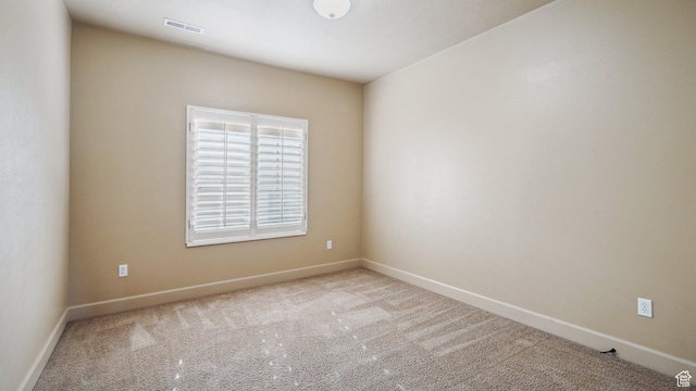 unfurnished room with visible vents, carpet flooring, and baseboards